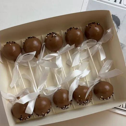 Boxed chocolate-coated cake pops tied with white ribbons - Popcakes Ottawa