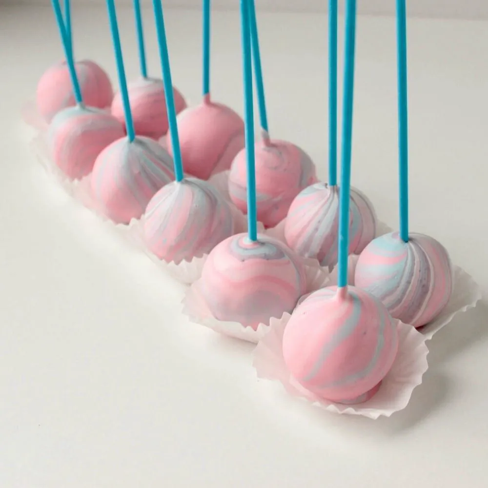 Pink swirl birthday cake pops with blue sticks - Popcakes Ottawa