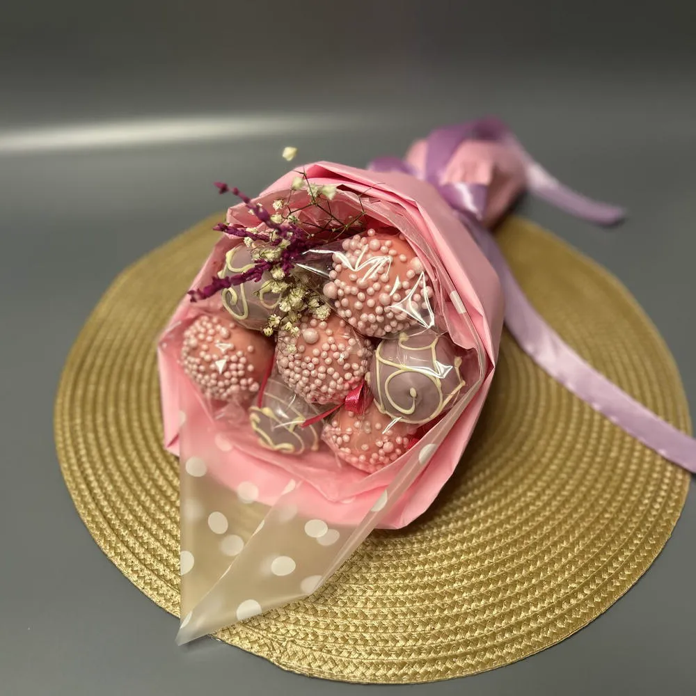 Overhead view of a pink cake pop bouquet on a gold placemat - Popcakes Ottawa