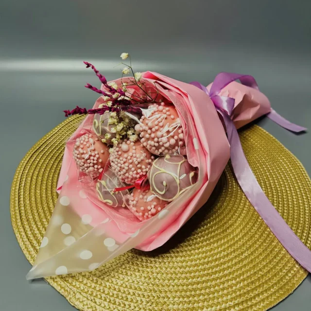 Pink-wrapped cake pop bouquet with sprinkles and decorative flowers - Popcakes Ottawa