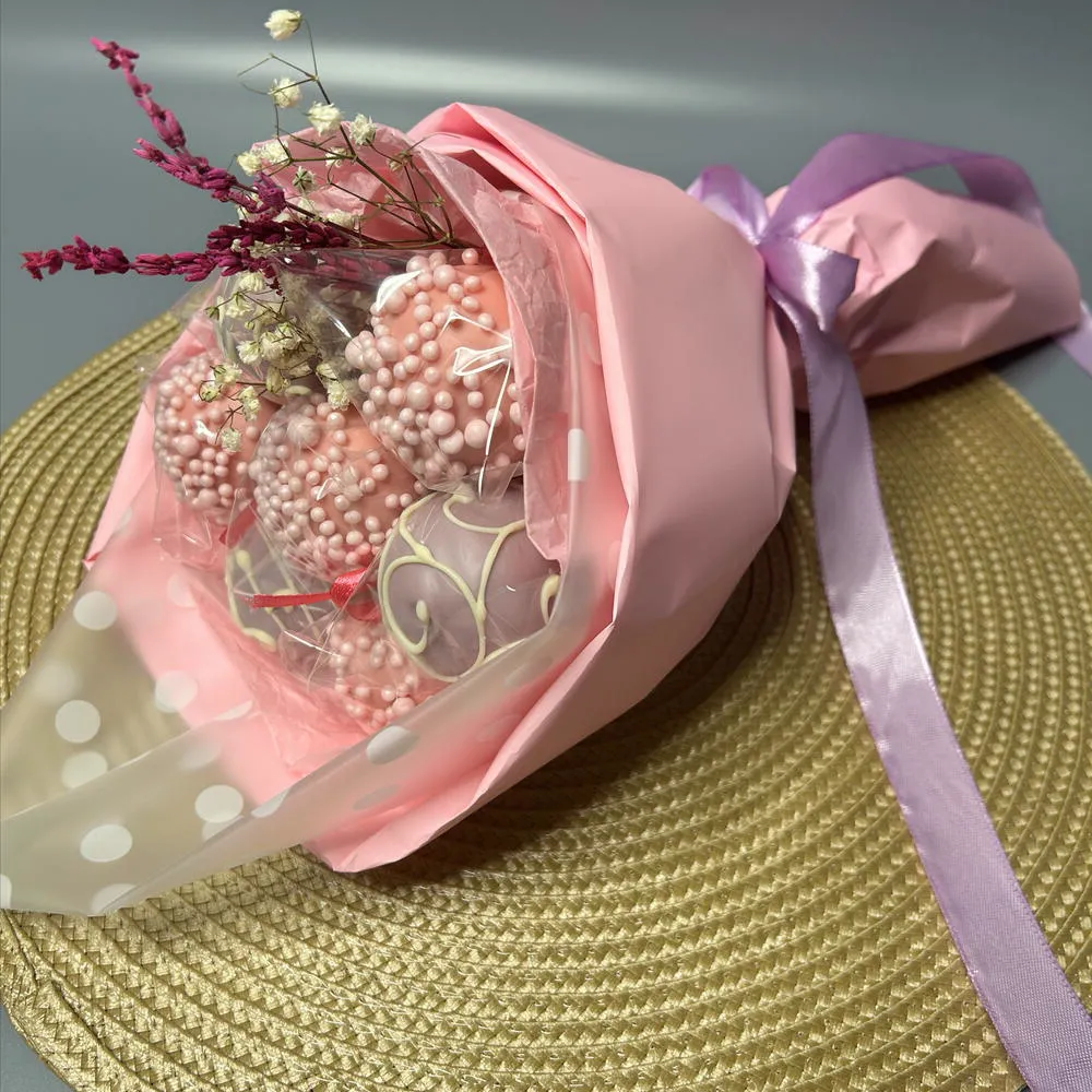 Side view of a cake pop bouquet with pink wrapping and lavender ribbon - Popcakes Ottawa
