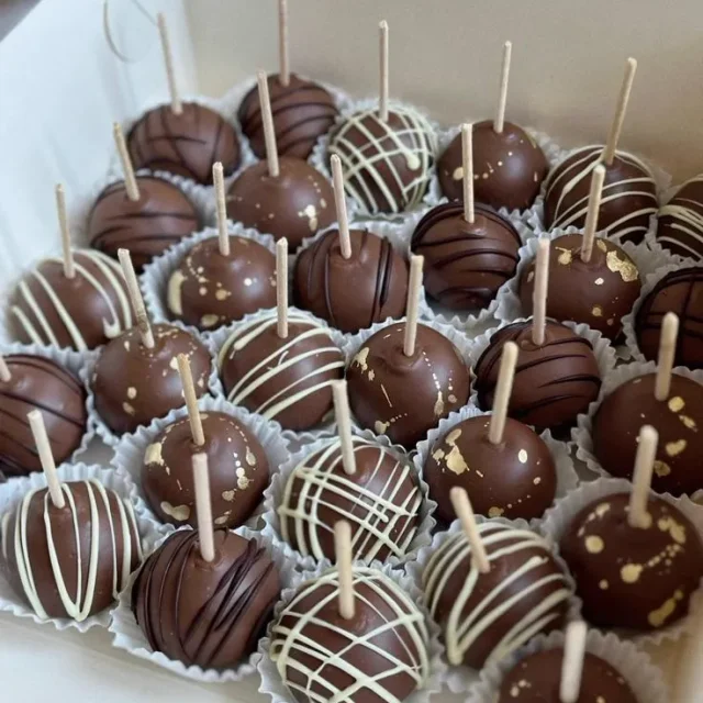 Box of chocolate-coated cake pops with contrasting drizzle - Popcakes Ottawa