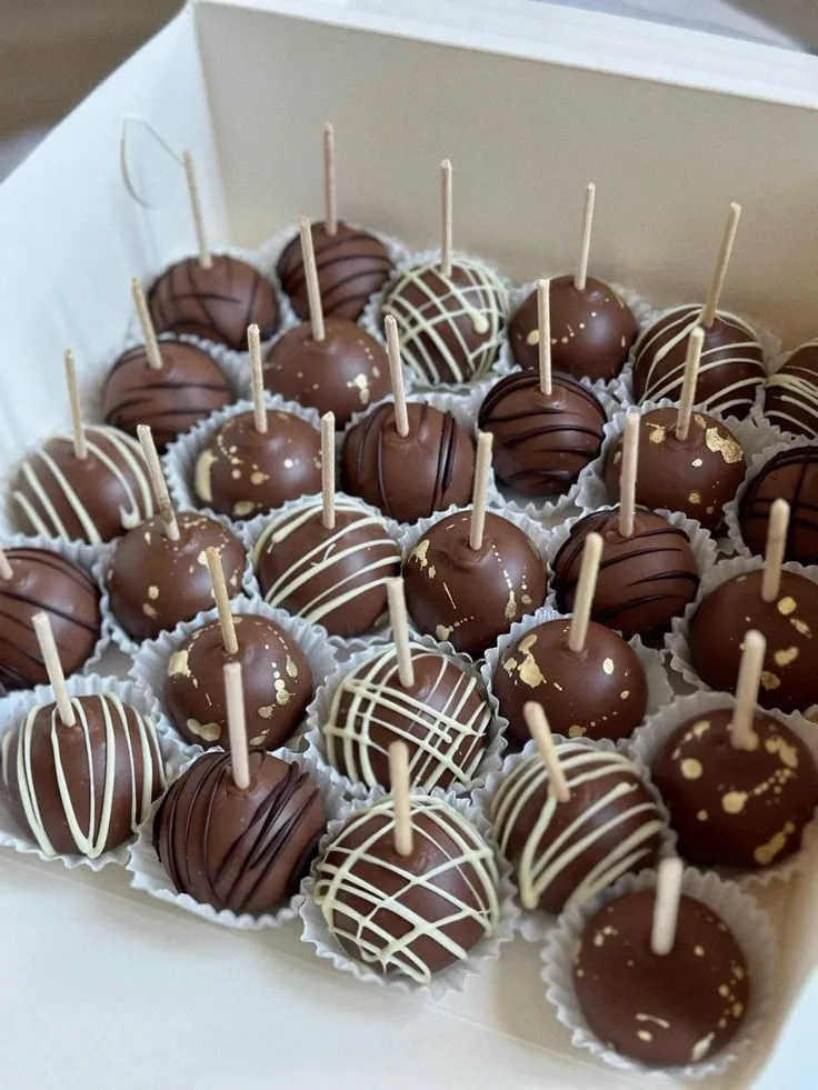 Box of chocolate-coated cake pops with contrasting drizzle - Popcakes Ottawa