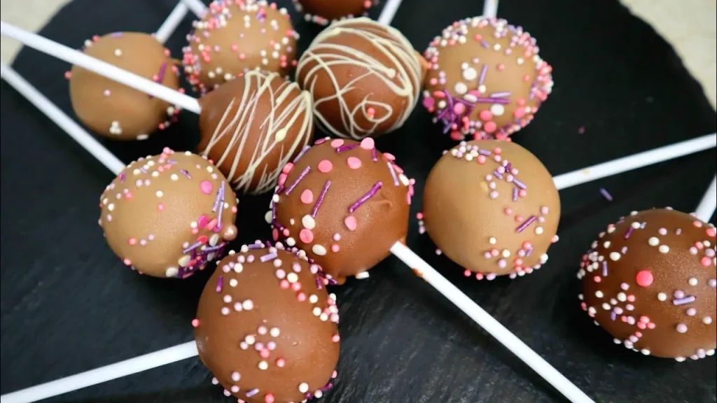 Chocolate-coated cake pops with sprinkles and drizzle - Popcakes Ottawa