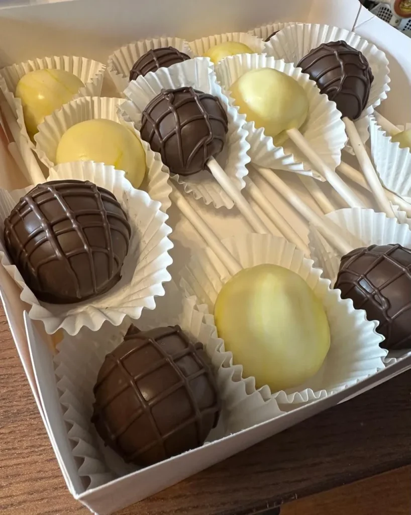 Close-up of chocolate drizzle and yellow cake pops in a box - Popcakes Ottawa
