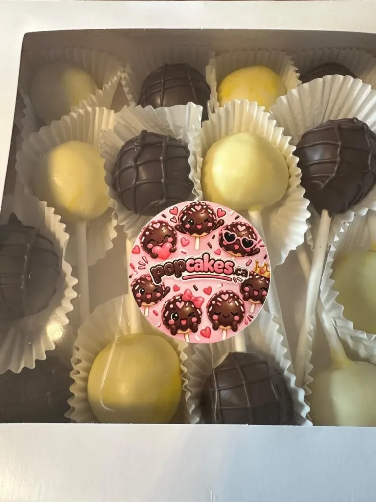 Chocolate and yellow cake pops in a box with Popcakes sticker - Popcakes Ottawa