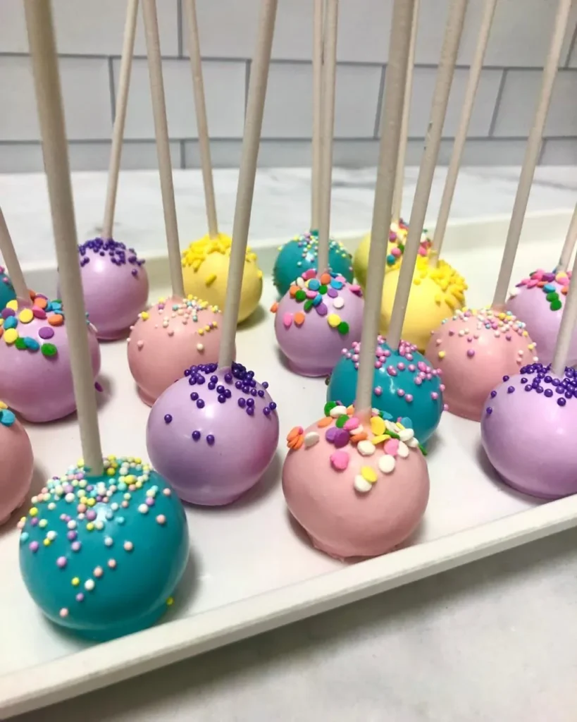 Colourful candy-dipped cake pops with sprinkles on a tray - Popcakes Ottawa