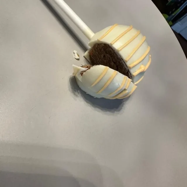 White drizzle cake pop cut open to show a chocolate centre - Popcakes Ottawa