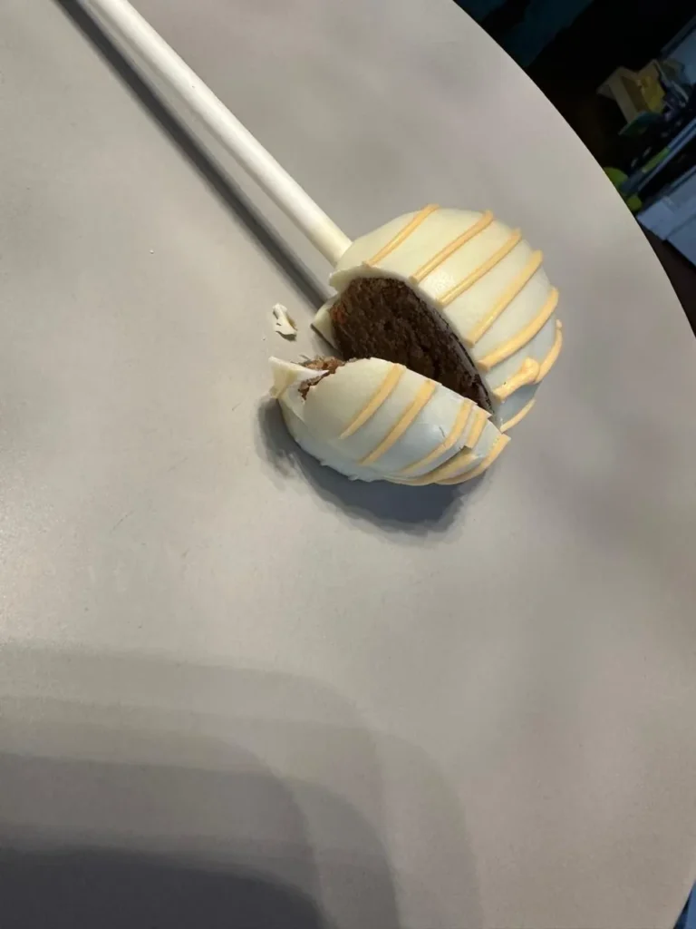 White drizzle cake pop cut open to show a chocolate centre - Popcakes Ottawa