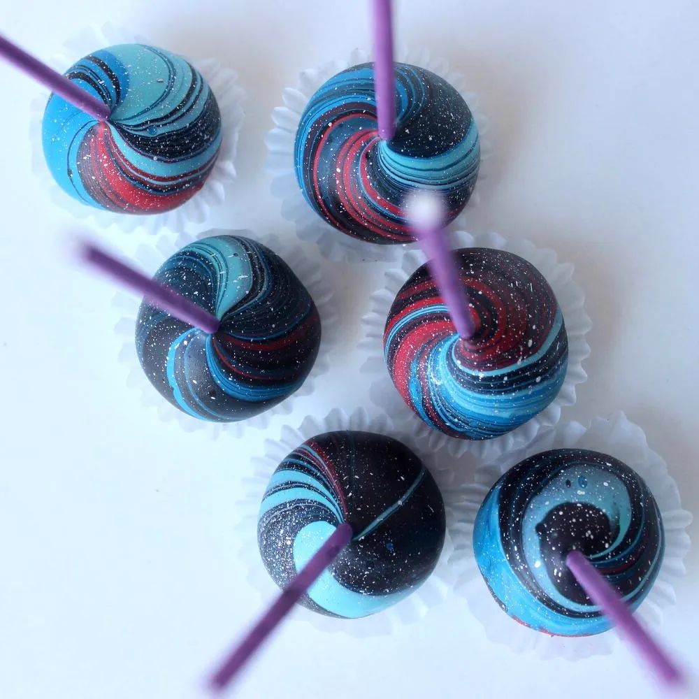 Overhead view of blue and red galaxy swirl cake pops - Popcakes Ottawa