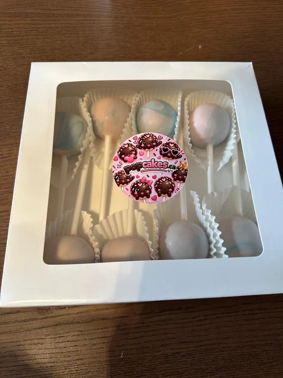 Pastel marbled cake pops in a gift box with Popcakes sticker - Popcakes Ottawa