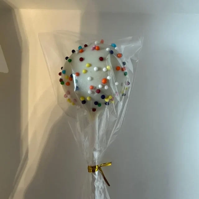 Wrapped white cake pop with rainbow sprinkles - Popcakes Ottawa