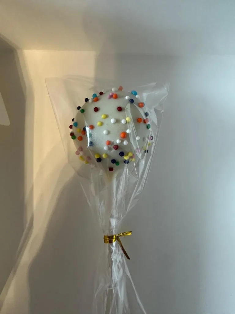 Wrapped white cake pop with rainbow sprinkles - Popcakes Ottawa
