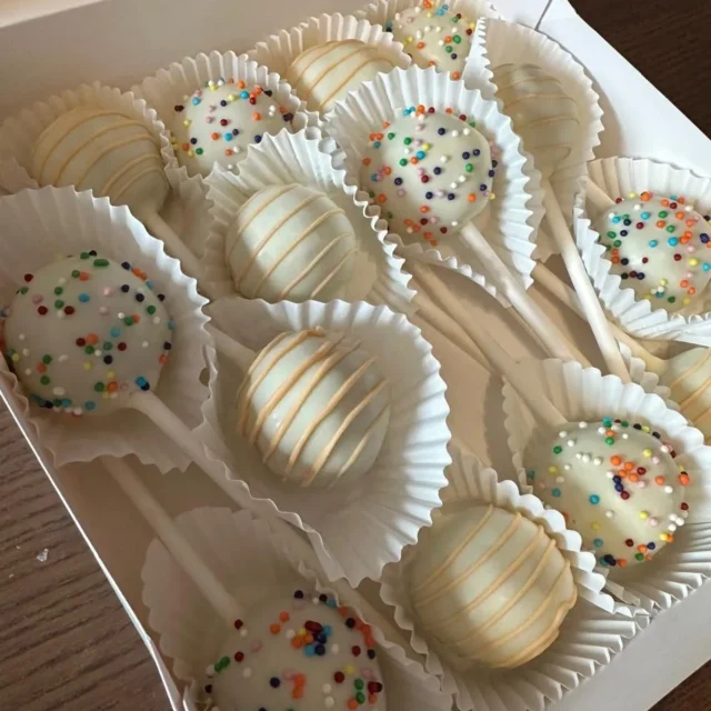 Overhead view of white sprinkle and drizzle cake pops in a box - Popcakes Ottawa