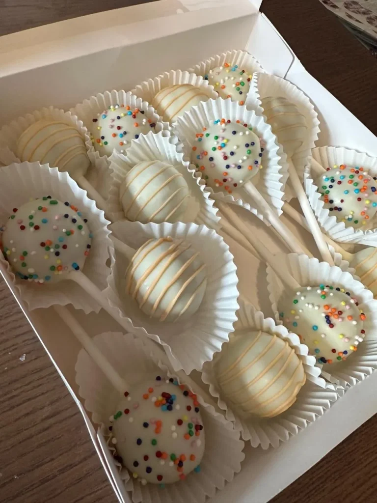 Overhead view of white sprinkle and drizzle cake pops in a box - Popcakes Ottawa
