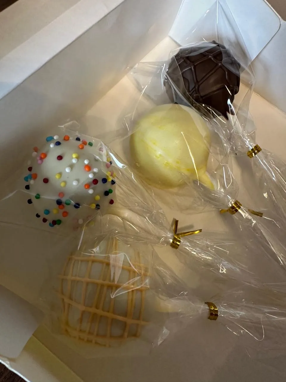 Assorted wrapped cake pops in an open box - Popcakes Ottawa