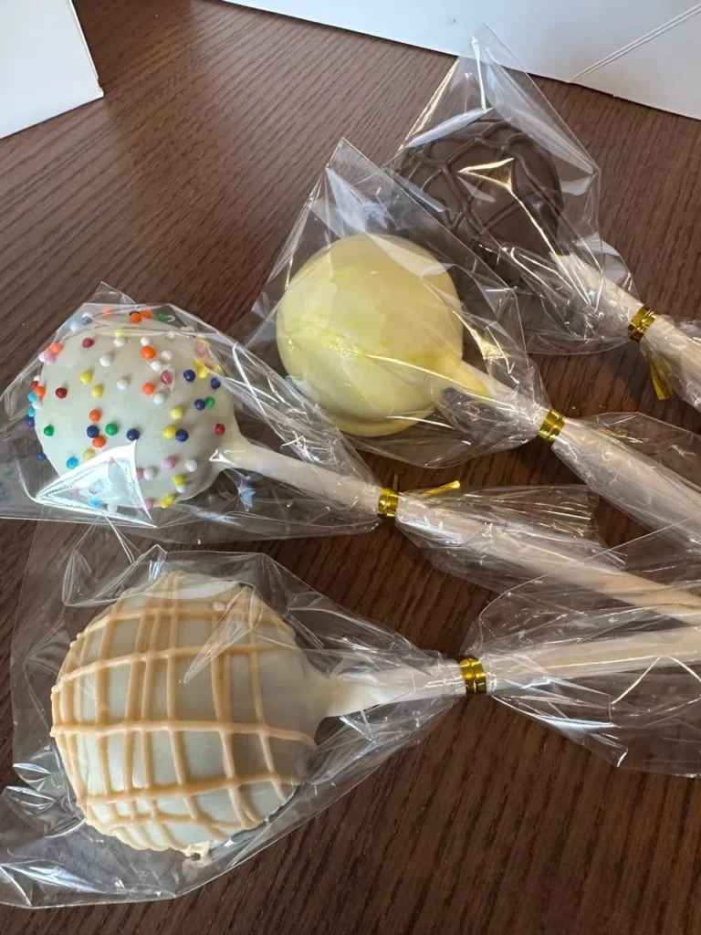 Assorted wrapped cake pop party favours on a table - Popcakes Ottawa