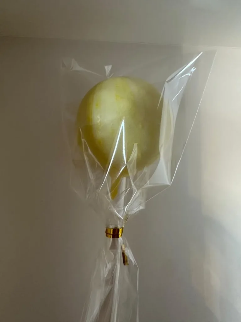 Wrapped yellow candy-dipped cake pop - Popcakes Ottawa